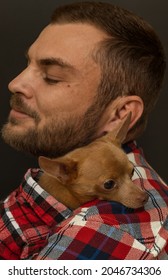 Close-up Portrait Of Man And A Small Lap Dog, Affectionate Hugs, Pets Love, And Care. 