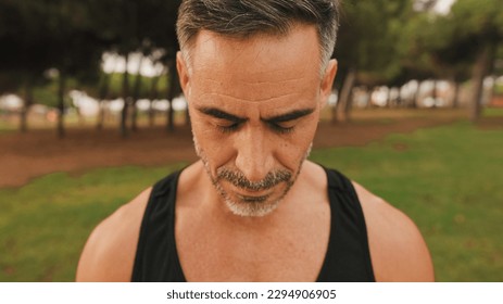 Close-up portrait of mature muscular man in sportswear looks at down  - Shutterstock ID 2294906905