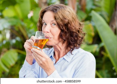 Close-up Portrait Of Mature Woman Drinking Herbal Tea