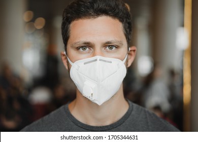 Close-up Portrait Of Men In Respirator Mask At The Airport. Coronavirus COVID-19 And Air Pollution Concept.