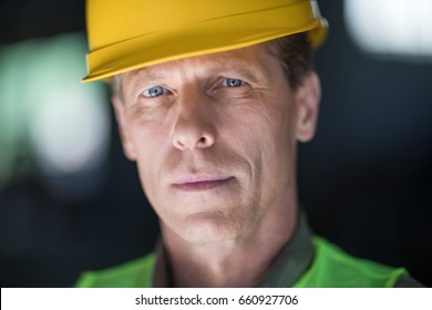 Close-up Portrait Of Middle Aged Builder In Hard Hat Looking At Camera 