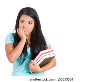 Closeup Portrait Of Nervous Student Carrying Books In One Arm And Biting Fingernails In Other, Isolated On White Background With Copy Space