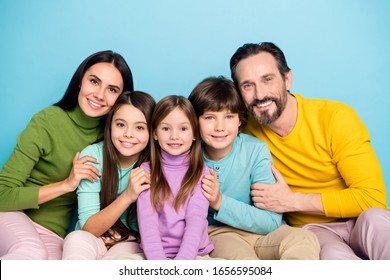 Close-up portrait of nice attractive careful affectionate friendly ideal cheerful cheery adorable family embracing enjoying holiday isolated on bright vivid shine vibrant blue color background