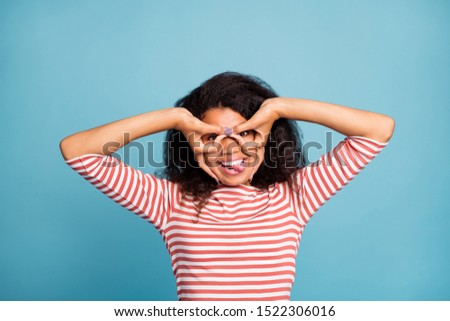 Close-up portrait of nice attractive cheerful cheery funky positive wavy-haired girl wearing striped pullover showing ok-sign fooling isolated on bright vivid shine vibrant blue color background