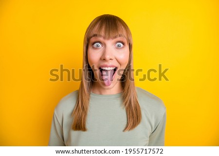 Close-up portrait of nice attractive foolish cheerful crazy girl teasing you having fun isolated over bright yellow color background