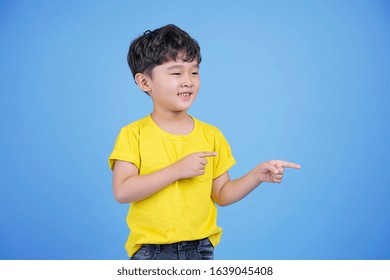 Close-up portrait of a nice attractive trendy cheerful cheery Korean little boy pointing up recommend decision solution isolated over bright vivid shine vibrant blue color background - Shutterstock ID 1639045408