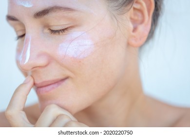 Closeup Portrait of a Nice Blond Female with Sun Cream on a Face. Closed Eyes. Using Spf Before Going to Beach. Health Care. Beauty Treatment at Spa.