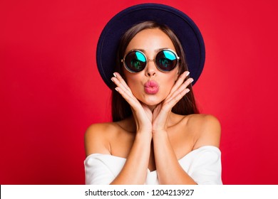 Close-up portrait of nice cool bright vivid attractive sweet lovely positive lady wearing white off-the-shoulders ruffles top blouse sending kiss holding cheeks in palms isolated over red background - Powered by Shutterstock