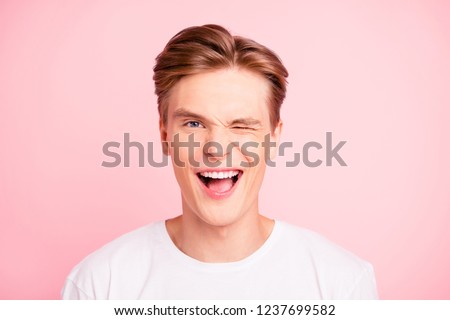 Close-up portrait of nice cute lovely attractive positive cheerful cheery well-groomed guy in white t-shirt flirting opened mouth isolated over pink pastel background