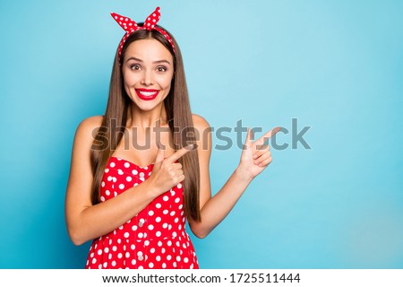Close-up portrait of nice-looking attractive lovely glamorous amazed glad cheerful cheery straight-haired girl showing copy space isolated over bright vivid shine vibrant blue color background