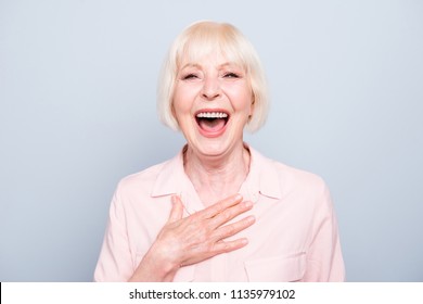 Closeup portrait of old adult caucasian blonde glad cheerful amazed surprised lady smiling, opened mouth, over grey background, isolated - Powered by Shutterstock