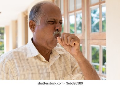 Closeup Portrait, Old Man Coughing With Post Nasal Drip Bug, Really Sick In Bad Weather, Holding Fist To Mouth, Isolated Outdoors Outside Background