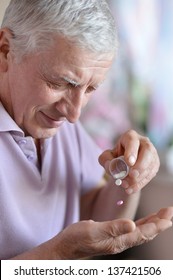 Close-up Portrait Of An Older Man Taking A  Medicine