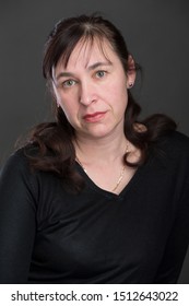 Close-up Portrait Of An Ordinary Middle-aged Woman.Forty Year Old Woman On Gray Background