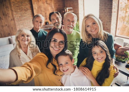 Closeup portrait photo of full big family gathering eight people make selfie cuddle embrace wait pray thank god have good autumn time make wish generation in home evening living room indoors