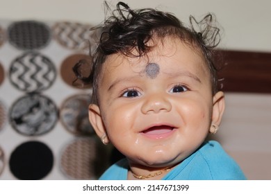 Close-up portrait photo of A lovely cute little Indian hindu baby boy looking at the camera with smiling face, india