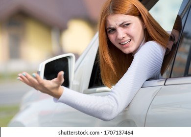 Closeup portrait of pissed off displeased angry aggressive woman driving a car shouting at someone with hand up. Negative human expression consept.