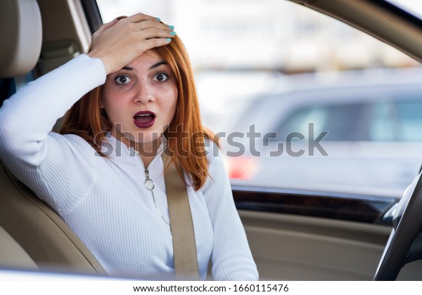 Closeup portrait of pissed off displeased angry\
aggressive woman driving a car shouting at someone. Negative human\
expression consept.