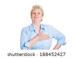 Closeup portrait, proud, happy senior mature woman pledging allegiance, hand on chest, head up, isolated white background. Positive human emotion facial expression feelings.