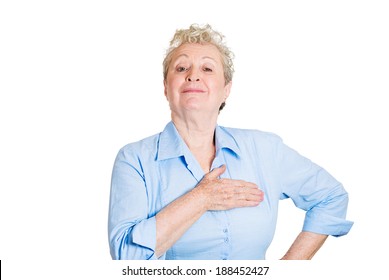 Closeup portrait, proud, happy senior mature woman pledging allegiance, hand on chest, head up, isolated white background. Positive human emotion facial expression feelings.