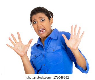 Closeup portrait of scared woman raising hands up in defense, afraid about to be attacked or avoiding an unpleasant situation, isolated on white background. Negative emotion facial expression feelings