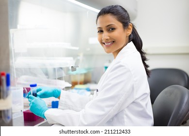 Closeup portrait, scientist holding 50 mL conical tube with blue liquid solution, laboratory experiments, isolated lab background. Forensics, genetics, microbiology, biochemistry