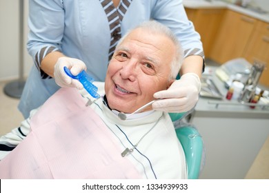 Closeup Portrait Of Senior Man In Dental Office Sitting In Dentist Chair. Dental Care For Older People. Dentistry, Medicine And Health Care Concept