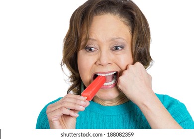 Closeup Portrait Senior Woman With Sensitive Tooth Ache Problem Pain From Cold Frozen Popsicle Ice Cream, Fist On Mouth, Isolated White Background. Negative Human Emotion, Facial Expressions, Feelings