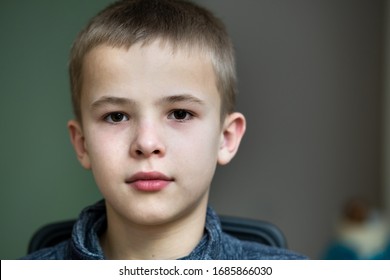 Closeup Portrait Of A Serious Child School Boy.