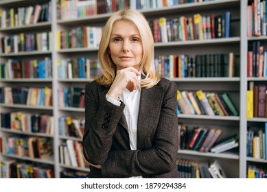 Close-up Portrait Of A Serious Successful Elegant Middle Aged Business Woman In A Formal Suit Looking Directly At The Camera. Senior Female Work As Office Employee Or Teacher