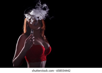 Close-up Portrait of sexy young hipster smoking (vaping) girl. Vapor concept. Vaping e-Cigarette.