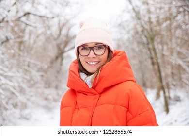 Close-up Portrait Shot Of A Happy Middle Aged Woman Wearing Hat While Standing Outdoor And Enjoy Winter Weather. 