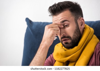 Close-up Portrait Of Sick Young Man With Sinus Infection Touching His Nose