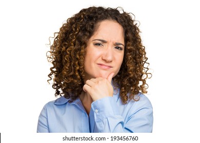 Closeup Portrait Skeptical, Upset Young Woman Looking Suspicious, Disgust On Face, Mixed Disapproval, Judgement Isolated White Background. Negative Human Emotion, Facial Expression, Feeling, Attitude