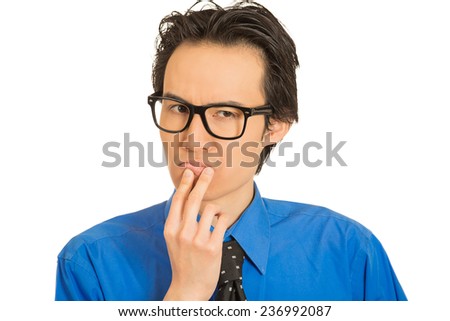 Closeup portrait skeptical young man funny suspicious annoyed looking guy being cautious careful attentive thinking on his own mind isolated white background. Emotion face expression body language