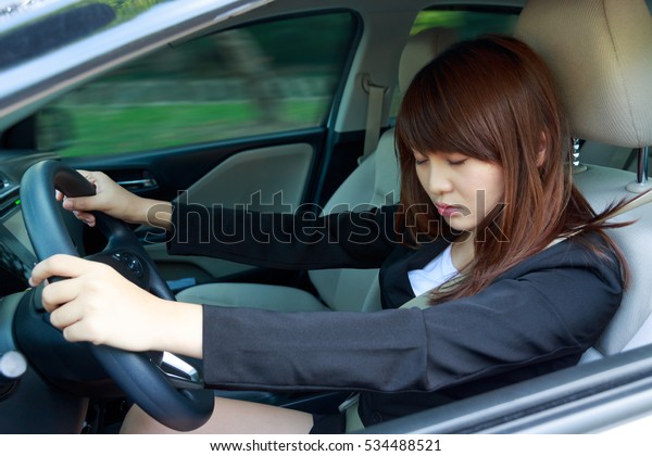 Closeup portrait sleep, tired, close eyes young\
woman driving her car after long hour trip, Sleep deprivation,\
accident concept