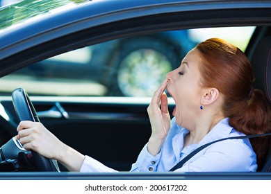 Closeup Portrait Sleepy, Tired, Fatigued, Exhausted Young Attractive Woman Driving Her Car After Long Hour Trip, Isolated Street Traffic Background. Transportation, Sleep Deprivation, Accident Concept