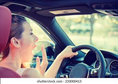 Closeup Portrait Sleepy, Tired, Fatigued, Exhausted Young Attractive Woman Driving Her Car After Long Hour Trip, Isolated Street Traffic Background. Transportation, Sleep Deprivation, Accident Concept