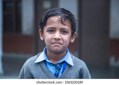 Closeup Portrait Of Smiling 6-7 Years Indian Kid, Standing Straight At School Campus In School Uniform And Looking At Camera