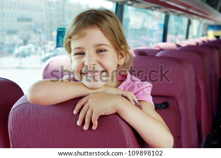 Closeup portrait of smiling girl on bus seat