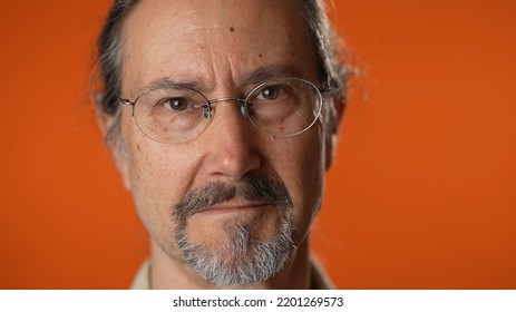 Closeup Portrait Of Smiling Happy Mature Man On Isolated On Solid Orange Background.