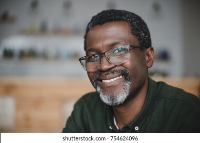 Close-up Portrait Of Smiling Mature African American Man In Bar