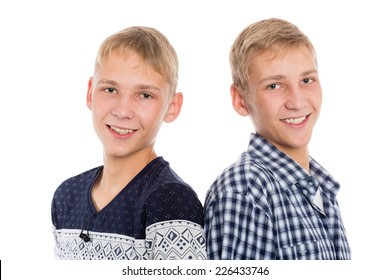 Closeup portrait of a smiling twin brothers isolated on white background