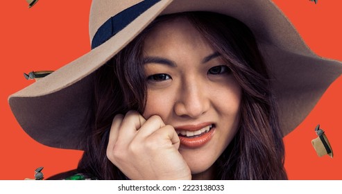 Close-up portrait of smiling young asian woman wearing hat with digital headwear. Digital composite, celebration, benefits of headwear, fashion, cultures, national hat day. - Powered by Shutterstock