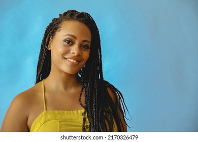 closeup portrait of smiling young beautiful african american woman braid hair posing at studio looking at camera shot - Powered by Shutterstock