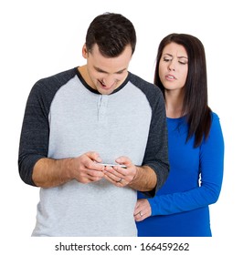 Closeup portrait of sneaky jealous possessive girlfriend watching boyfriend happily texting someone else, isolated on white background. Negative emotion facial expression feelings conflict concept
