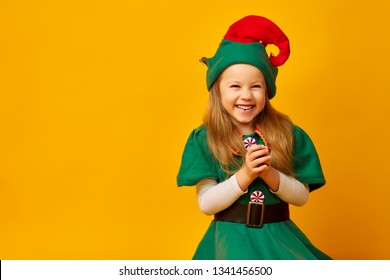 Closeup Portrait Of Sneaky Sly Cunning Wicked Child Elf, Plotting Something Bad, Revenge Isolated Yellow Background. Negative Human Emotions Facial Expression Feeling Attitude Body Language