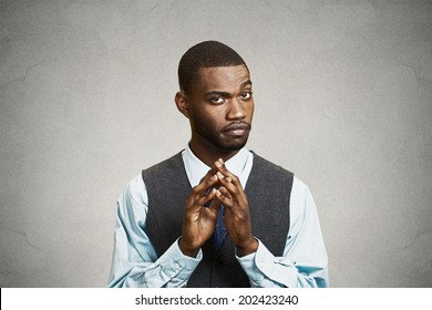 Closeup Portrait, Sneaky, Sly, Scheming Young Business Man, Worker Trying To Plot Something, Screw Someone, Isolated Black Background. Negative Human Emotions, Facial Expressions, Feelings, Attitude