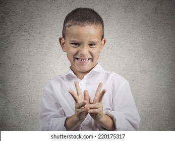 Closeup Portrait Sneaky Sly Scheming Child Boy Plotting Something Bad, Revenge Isolated Grey Background. Negative Human Emotion Facial Expression Feeling Attitude Body Language. Children Competition