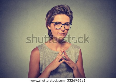 Closeup portrait of sneaky, sly, scheming young woman in glasses trying to plot something, screw someone isolated on gray background. Negative human emotions, facial expressions, feelings, attitude